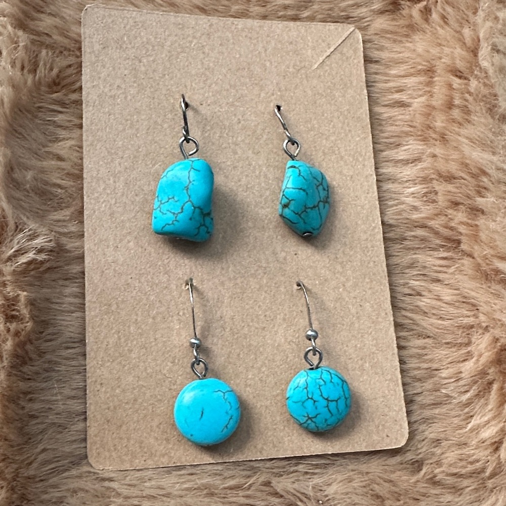 Two pairs of turquoise dangle earrings.